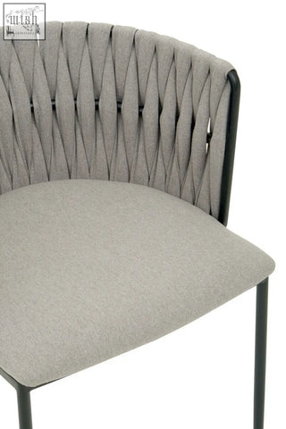 Grey dining chair with woven back and black metal frame perfect for stylish dining areas