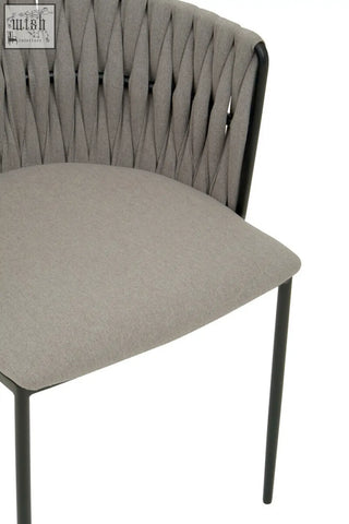 Modern grey dining chair with woven back, cushioned seat, and sleek black metal legs for stylish dining rooms