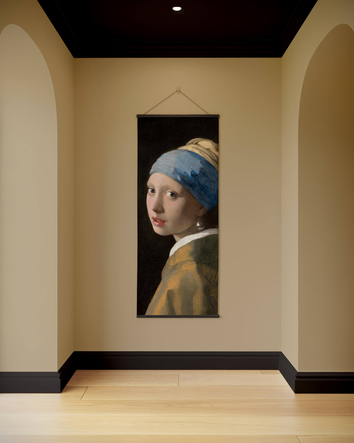 A vertical pearl earring tapestry featuring vermeer girl with pearl earring in blue headscarf on beige wall