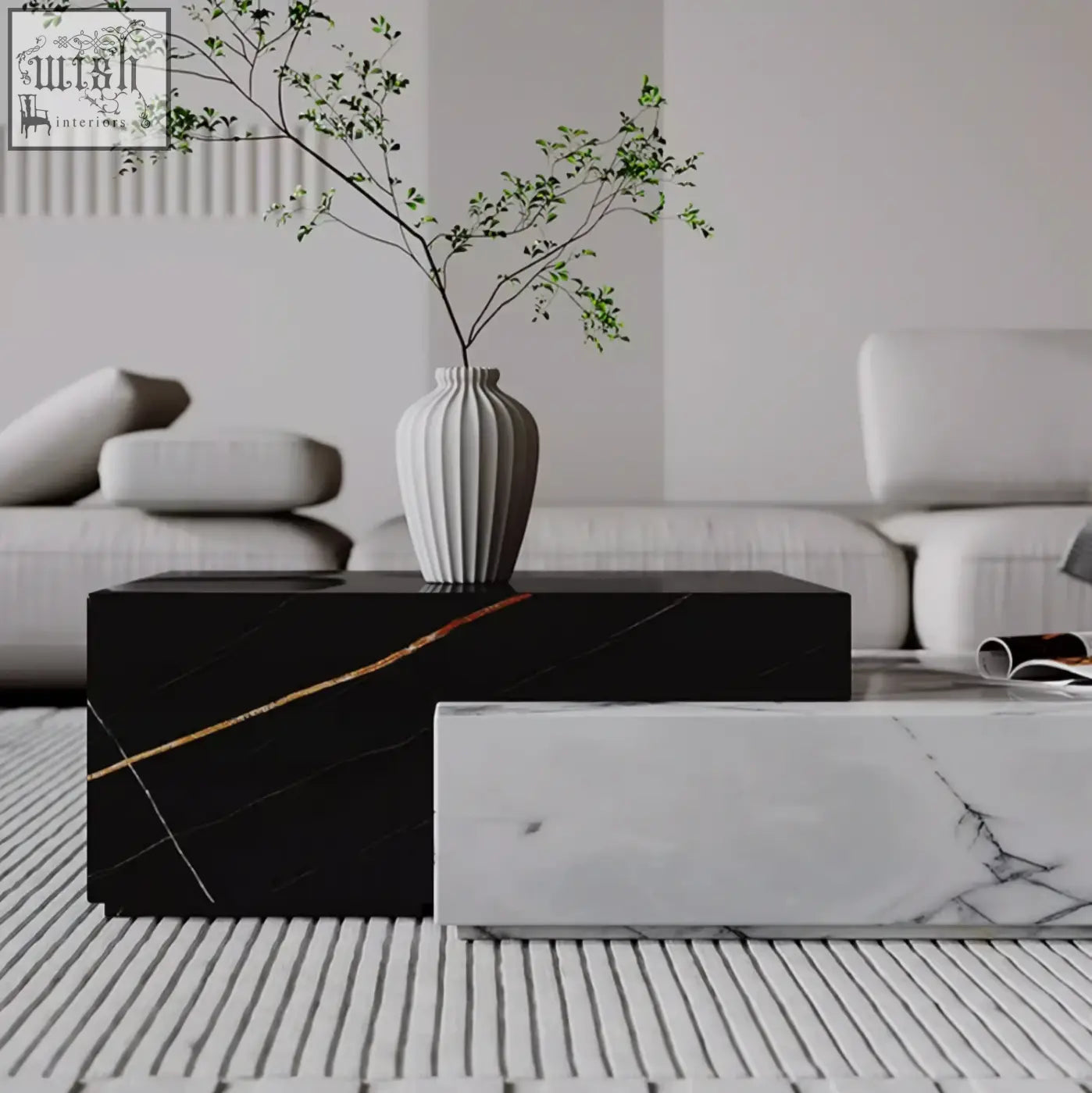 A sleek white ceramic vase with green branches on a stone giuli marble coffee table set centerpiece