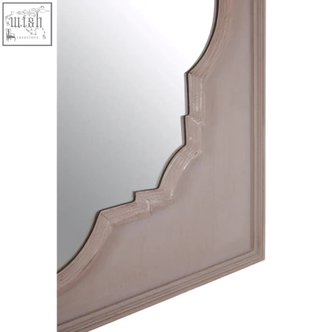 A dusty rose wooden mirror with an ornate scalloped frame from the gladys fossil grey wall mirror collection