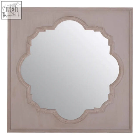 Gladys fossil grey wall mirror with a square frame, distressed pinkish-grey finish, and ornate quatrefoil design