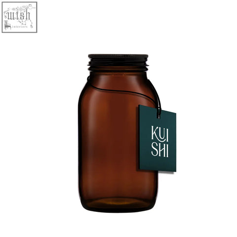 A sleek amber glass storage jar with a black screw-top lid and a dark green kui shi tag perfect for glass storage