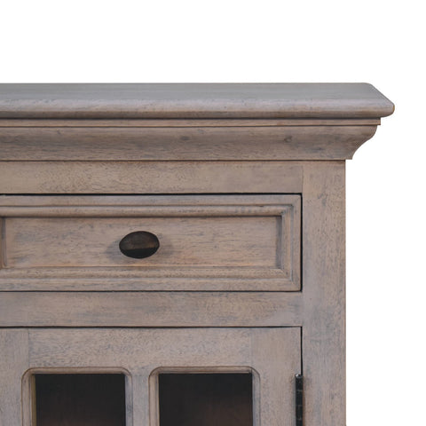 Light gray distressed wood glazed stone bedside table with single drawer glass door and oval black metal handle
