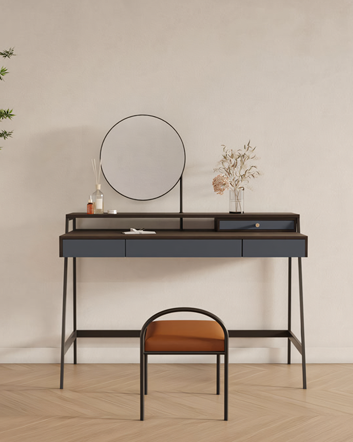 Modern navy blue glazier dressing table with black metal frame and round mirror paired with orange stool