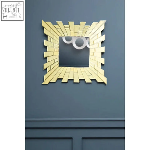 Glitzy small square wall mirror with gold-toned sunburst design and three circular cutouts at the top