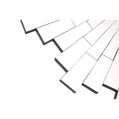 White rectangular tiles with black edges in a diagonal pattern framing a glitzy sunburst design round wall mirror