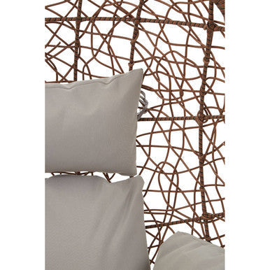 Light gray cushion resting against woven lattice of brown rattan hanging chair for cozy outdoor seating