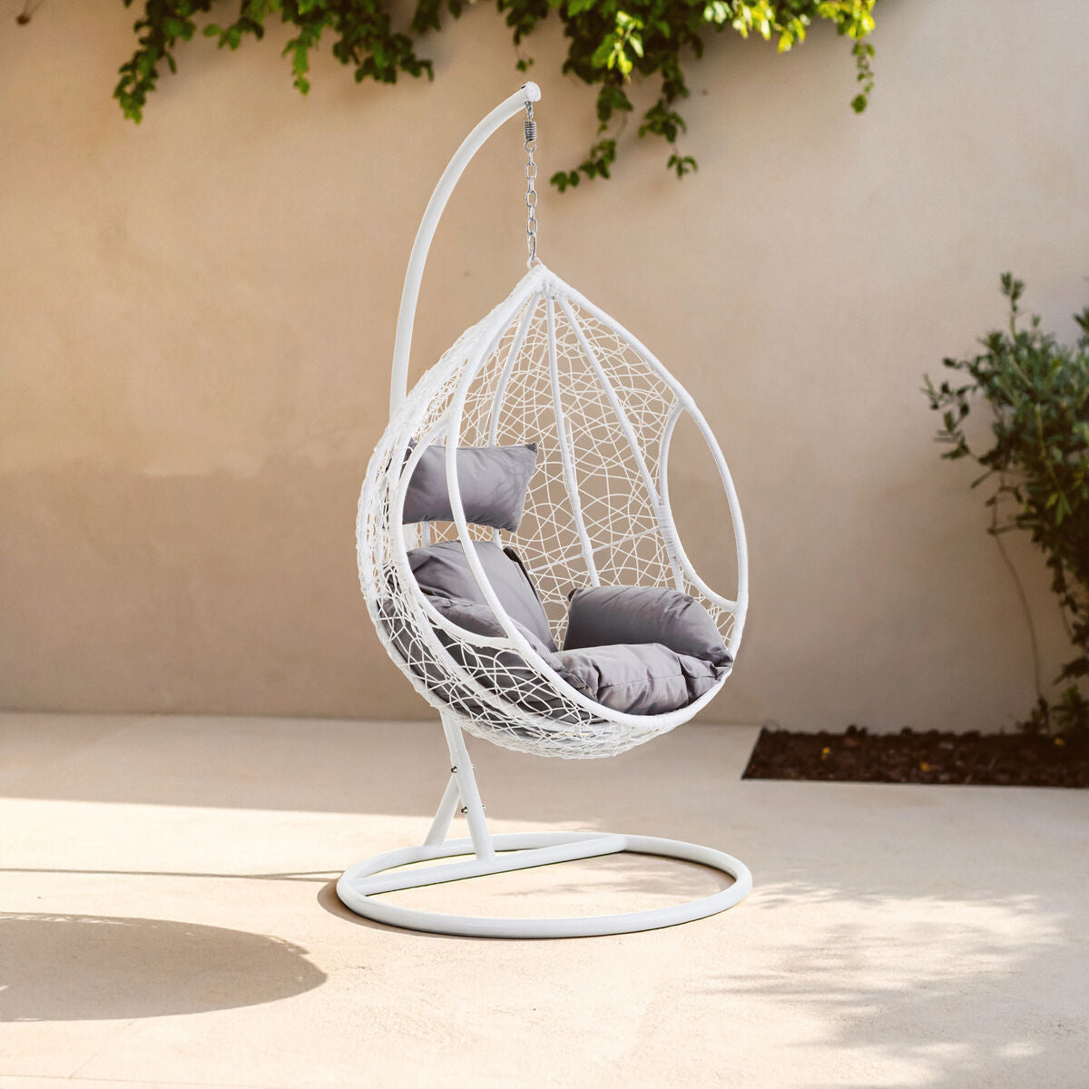Goa white rattan hanging chair with grey cushions featuring a white woven egg shape for cozy outdoor seating