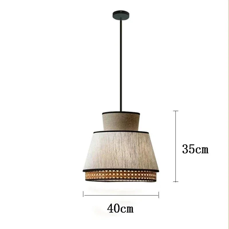 A modern gokna light pendant with two-tiered beige fabric shade and woven rattan trim on a black metal rod