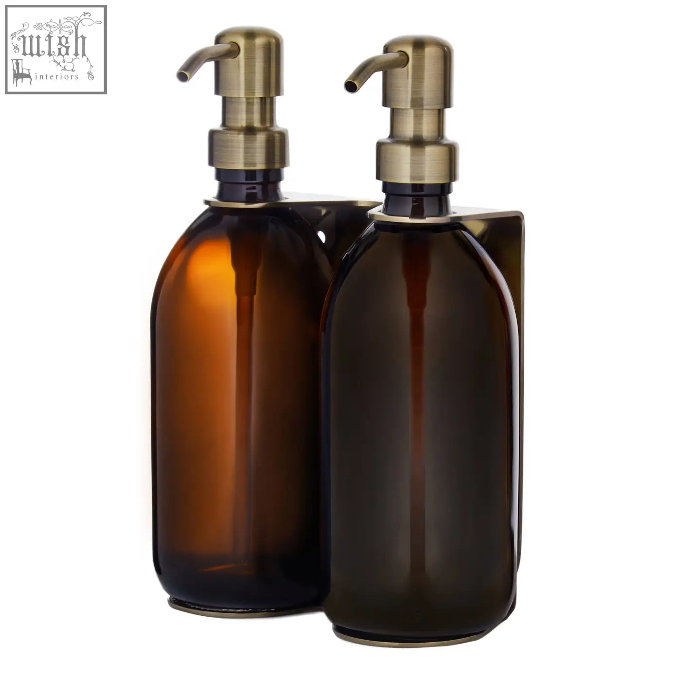 Two refillable glass bottles with brass pump tops in a gold double wall mounted soap dispenser set