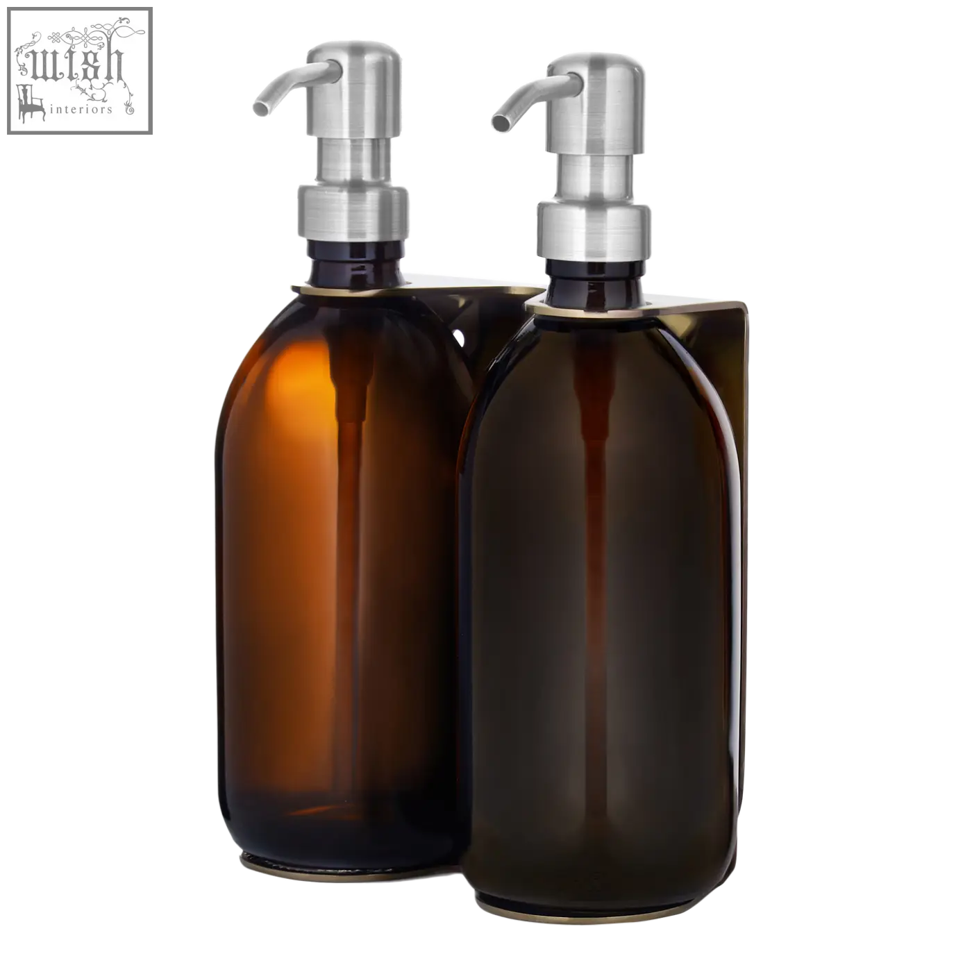 Two amber refillable glass bottles with sleek silver stainless steel pumps in a gold double wall mounted soap dispenser