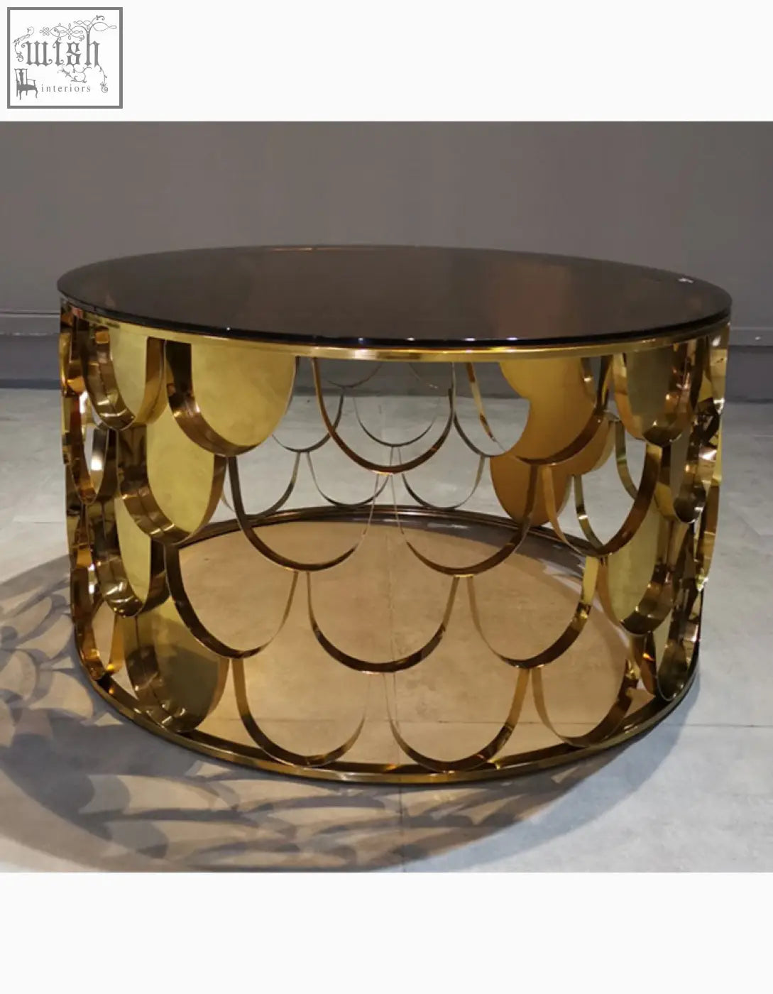 Gold nesting coffee table with a gold metallic scalloped base and sleek circular glass top for stylish living rooms