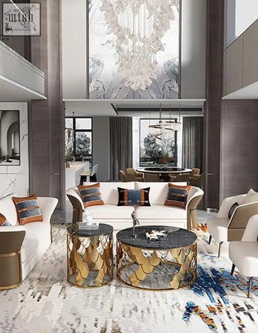 Gold nesting coffee tables with gold fish-scale pattern bases and black marble tops perfect as a stylish coffee table