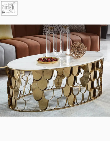 Gold nesting coffee table with an oval white marble top and a scalloped gold coffee table base