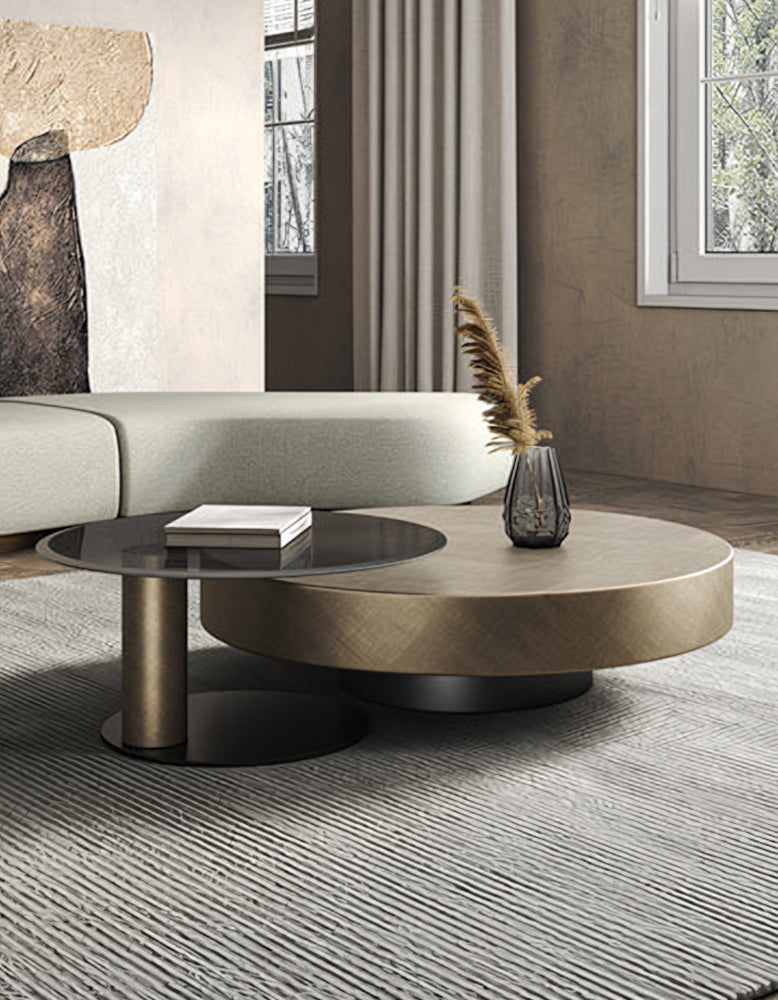 Modern gold coffee table with matte gold top glass surface and sleek black cylindrical base for stylish living room