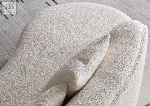 Cream-colored plush boucle cushion with soft rounded contours on goldie gubi three seater sofa white