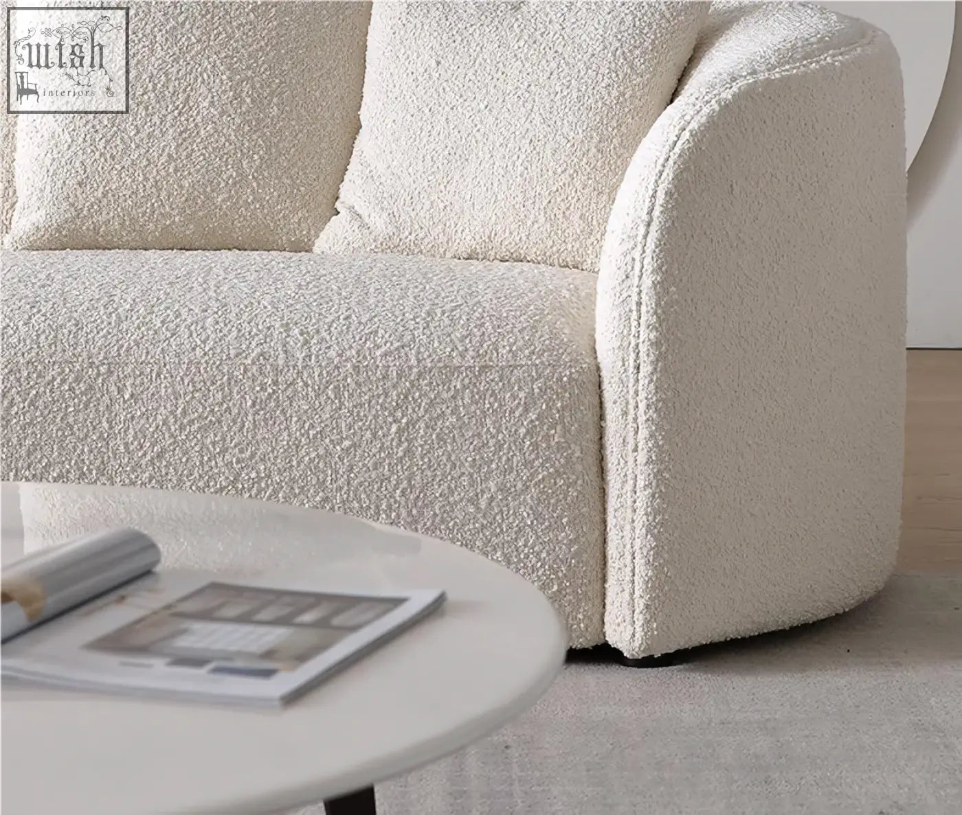 Cream-colored plush boucle three seater sofa with rounded armrests and cushions goldie gubi three seater