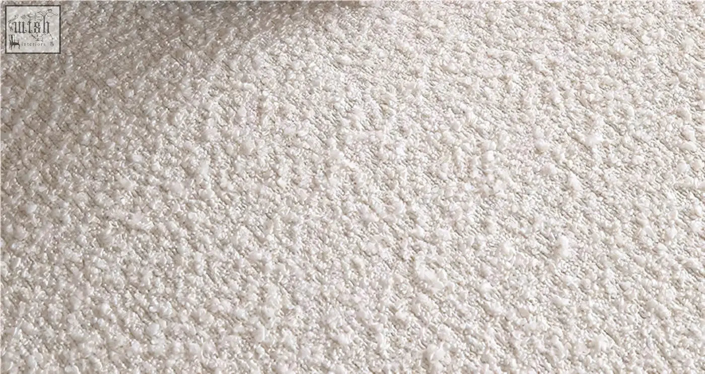 Cream-colored plush bouclé fabric detail on the goldie gubi three seater sofa in white with soft textured surface
