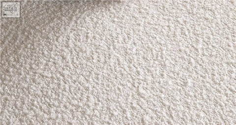 Cream-colored plush bouclé fabric detail on the goldie gubi three seater sofa in white with soft textured surface