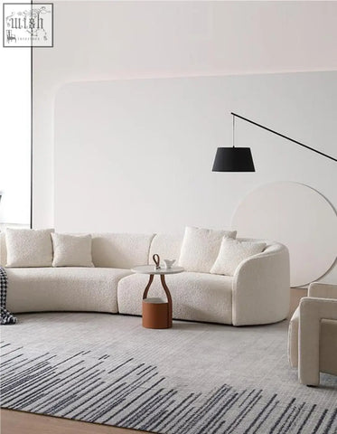Cream-colored plush goldie gubi three seater sofa with soft boucle upholstery and rounded armrests