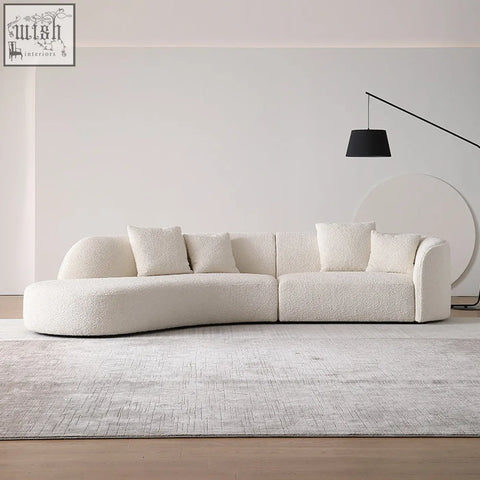 Cream-colored goldie gubi three seater sectional sofa with plush boucle fabric and curved design