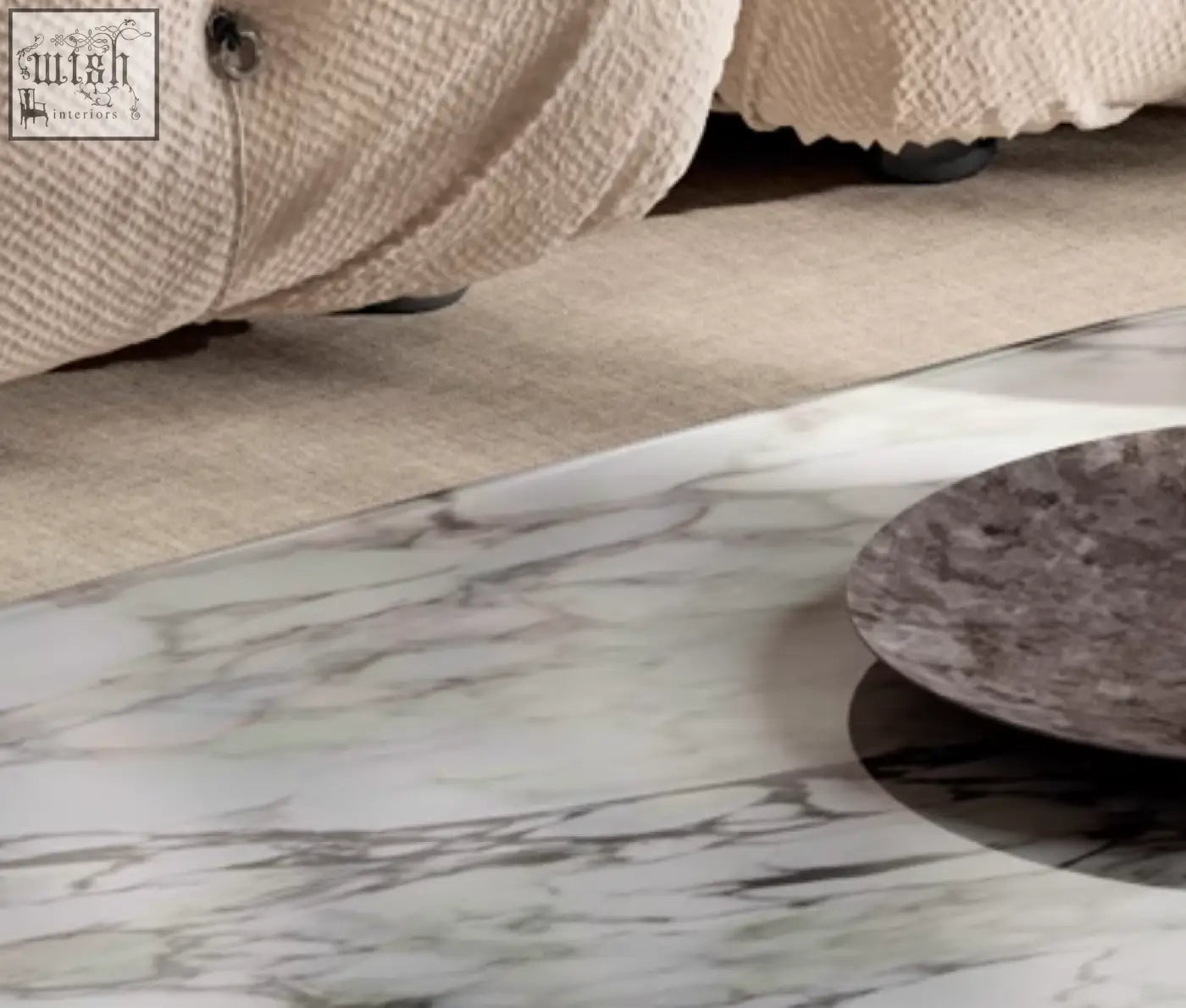 A dark gray textured ceramic plate on white marble surface part of the goliah coffee table set with marble top