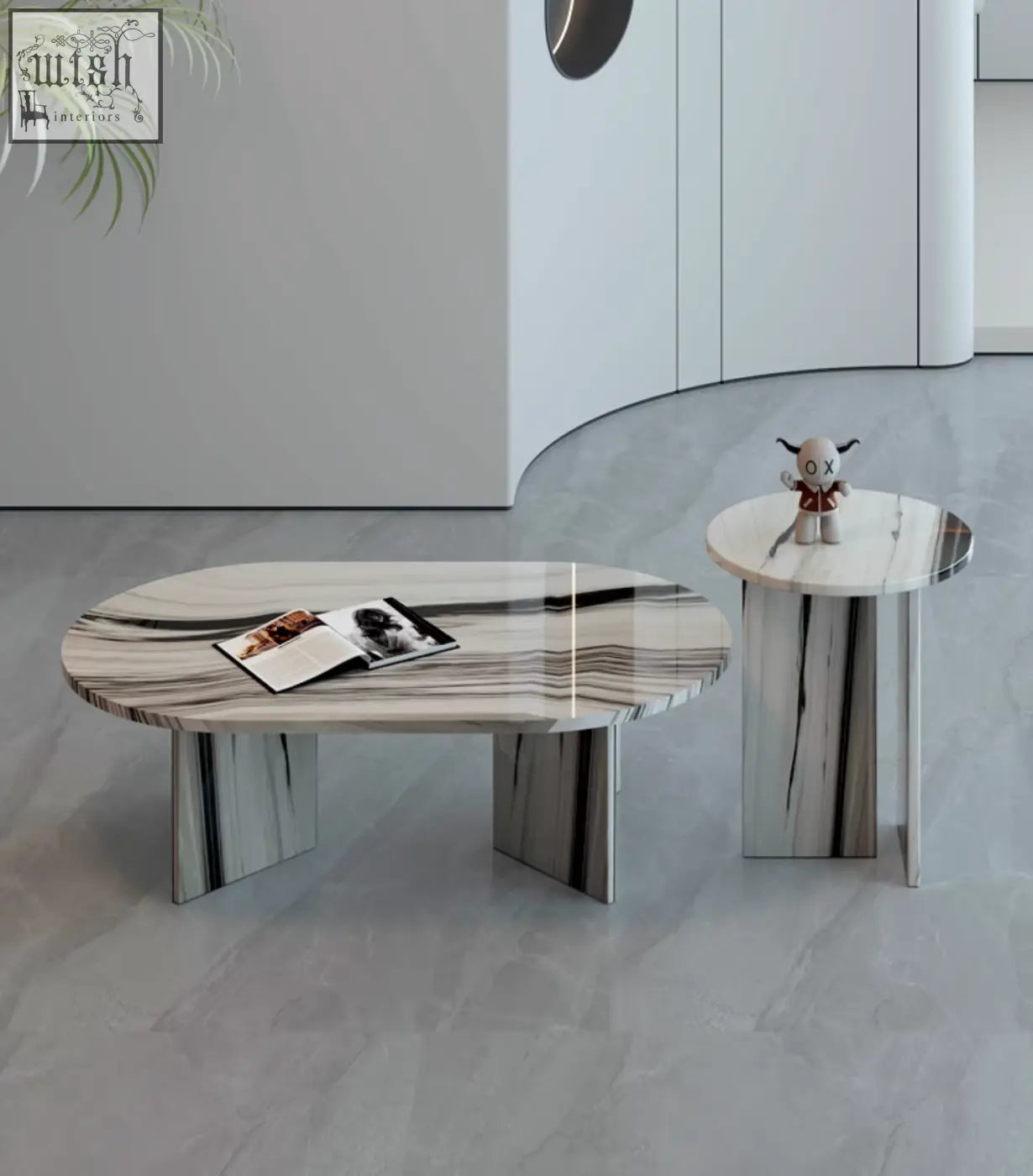 Modern goliah coffee table set with oval white and gray marble top and minimalist metallic legs perfect for living rooms