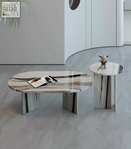 Modern goliah coffee table set with oval white and gray marble top and minimalist metallic legs perfect for living rooms