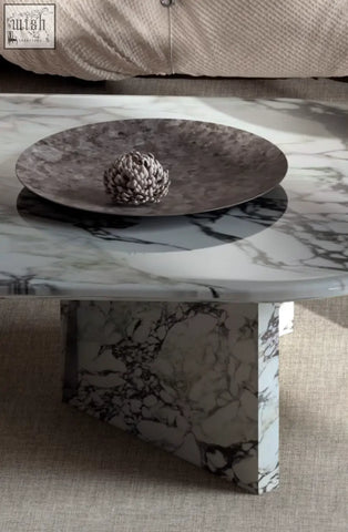 A sleek goliah coffee table set with a white and gray marble top and matching pedestal base for modern living rooms