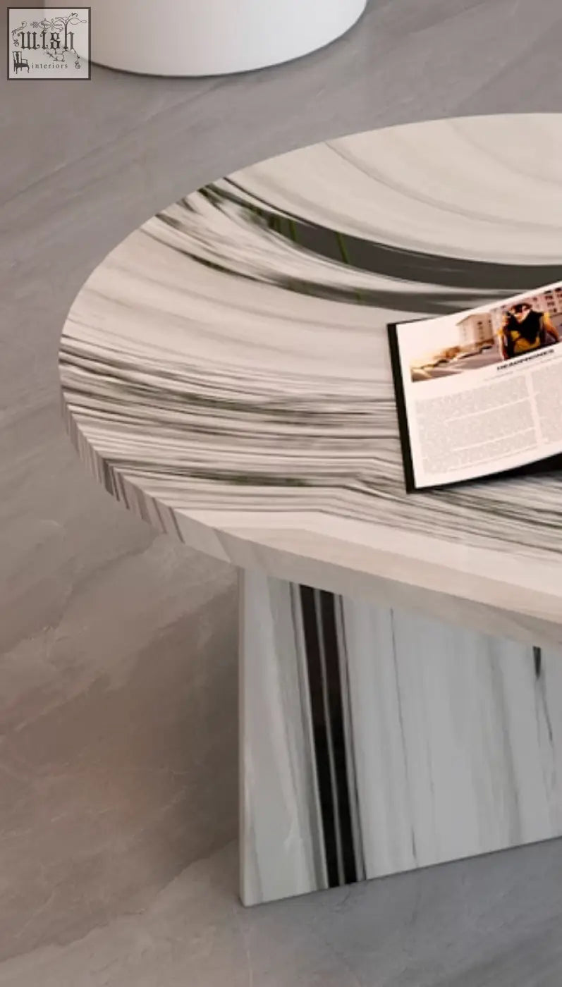 A sleek goliah coffee table set with a round polished white and gray marble top featuring black veining