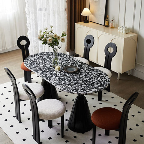 Gordon dining table black and marble with a glossy black and white speckled oval top perfect for dining spaces