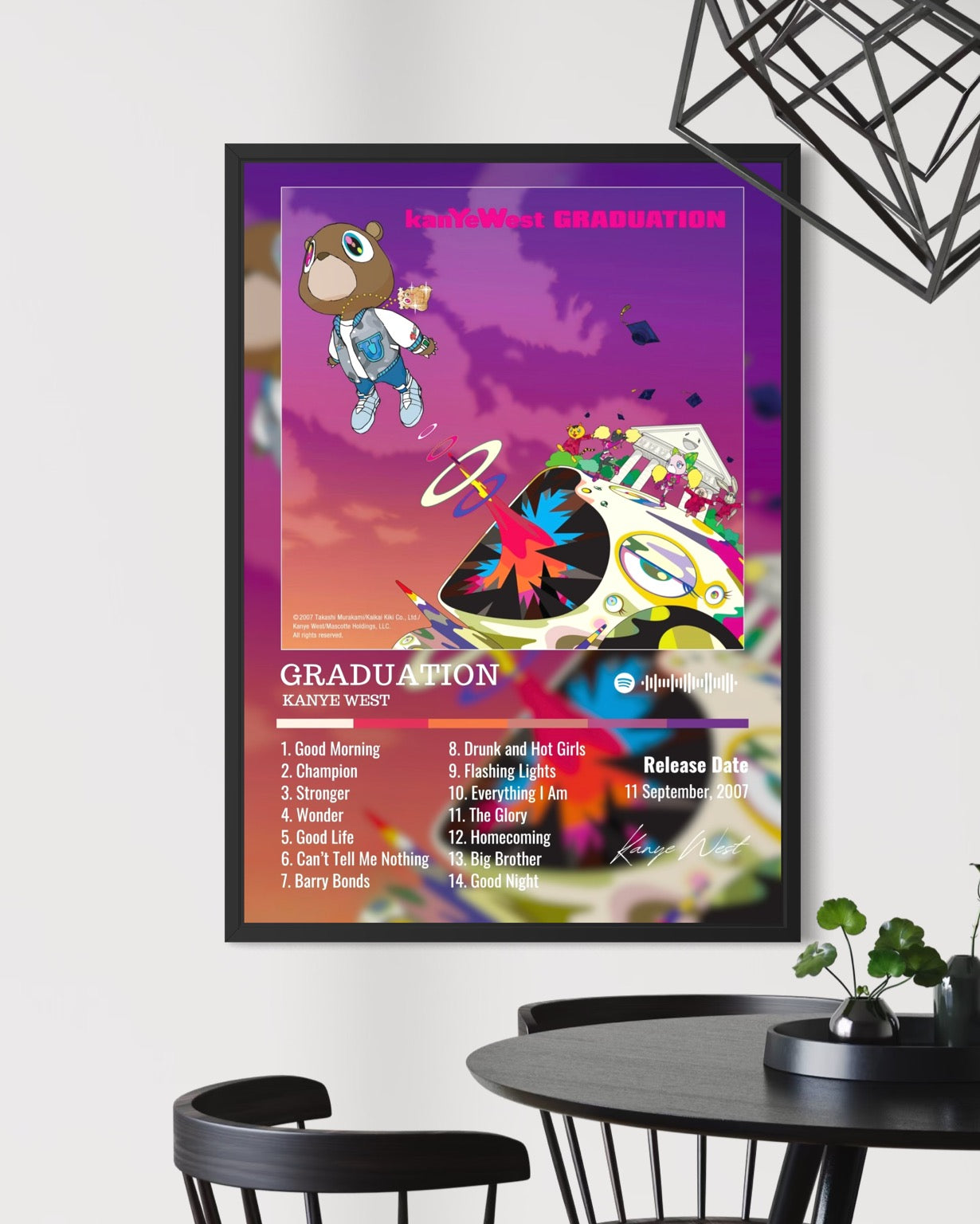 A framed kanye west graduation album poster with a vibrant purple pink gradient and cartoon tracklist design