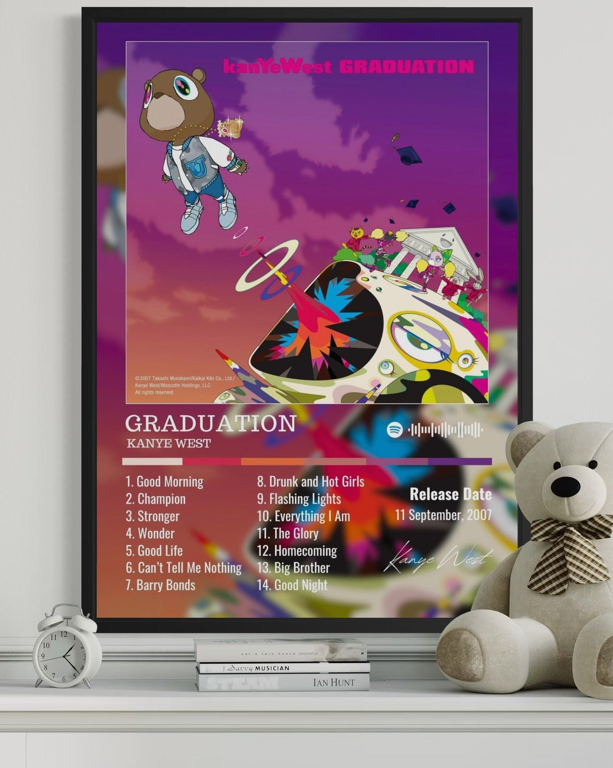 Framed kanye west graduation album poster with cartoon bear flying over a stylized car on purple orange background