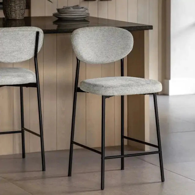 Gray fabric bar stool with black metal legs and curved backrest, modern design.