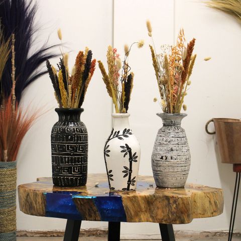 Three lombok ceramic vases in black etched, white leaf pattern, and gray textured on a rustic table for dry flowers