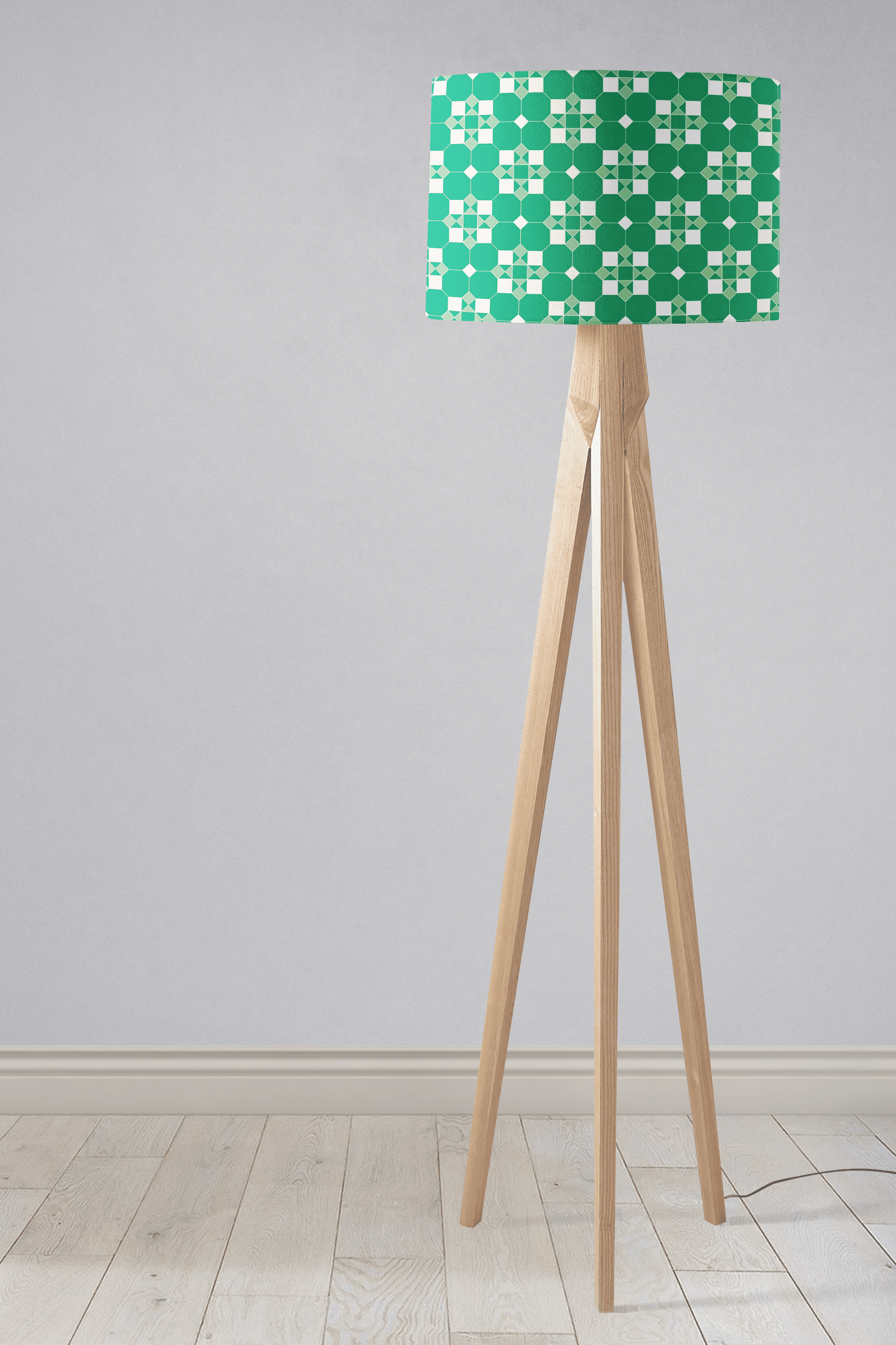 Green and white geometric tiles design lampshade on light wood tripod base perfect as a table lamp shade