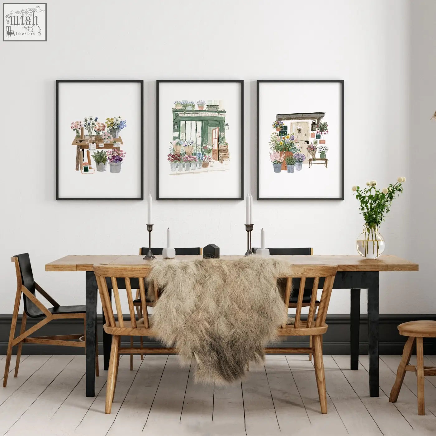 Three framed green art botanical prints hang above a wooden dining room table as decorative wall art prints set of 3