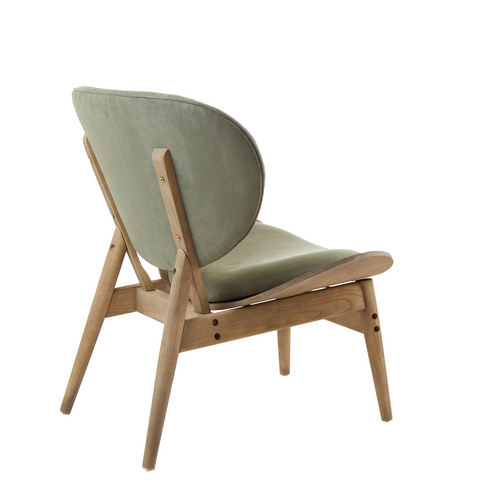 A green velvet chair with slender natural wood grey elm legs and light green upholstery perfect for modern lounges