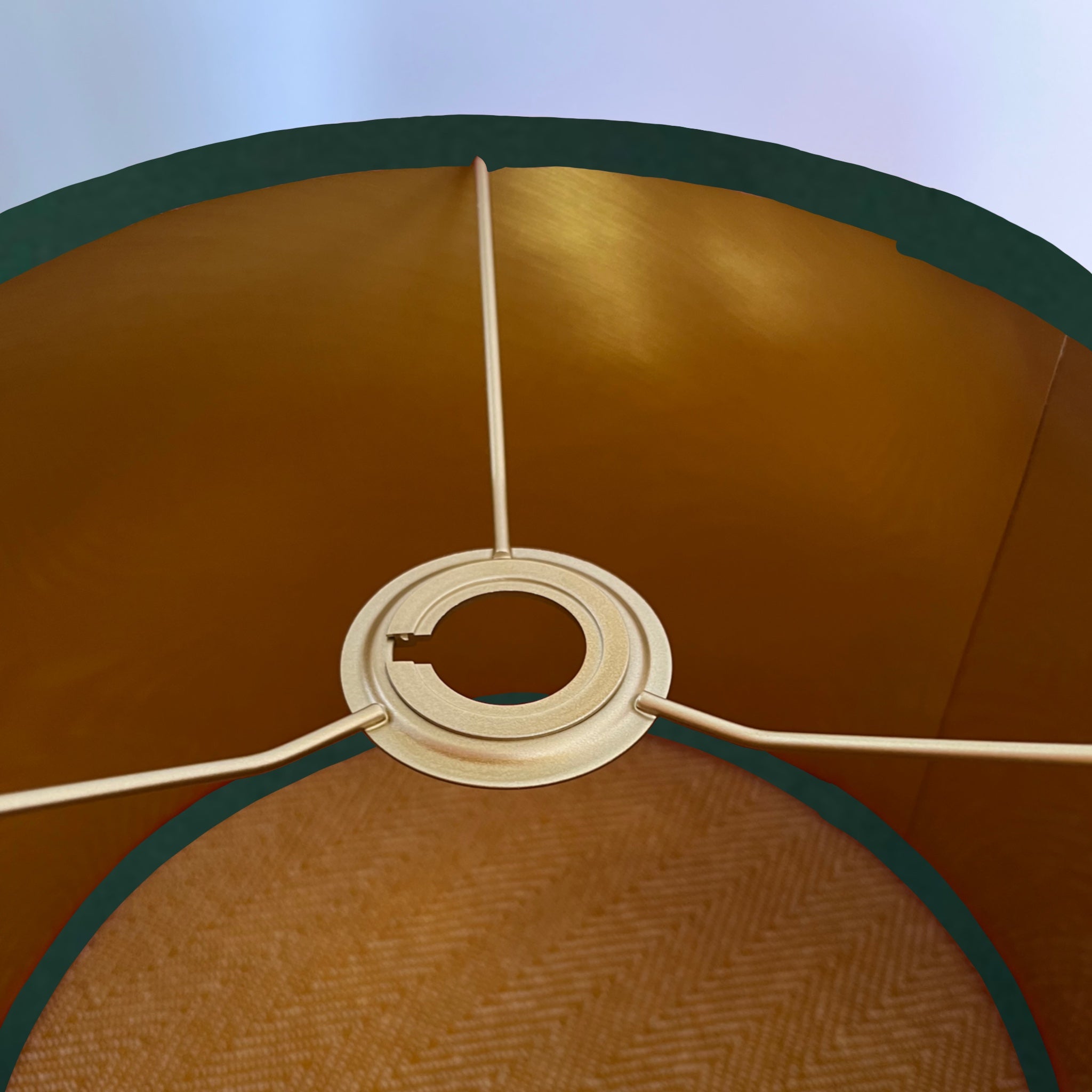 Interior of a 30cm height green plain velvet drum ceiling shade with a warm brushed gold lining and metal support ring