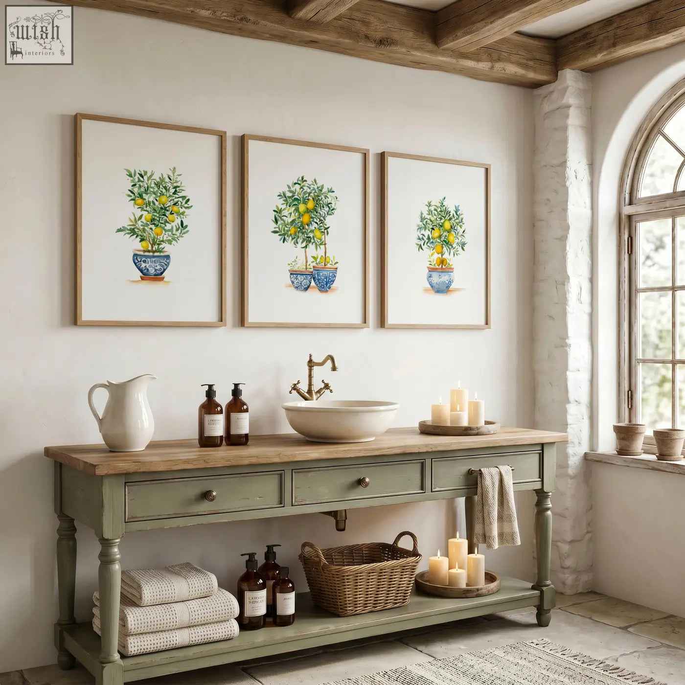 Green wall art featuring a lemon tree watercolor print above a green painted wooden vanity with brass faucet sink