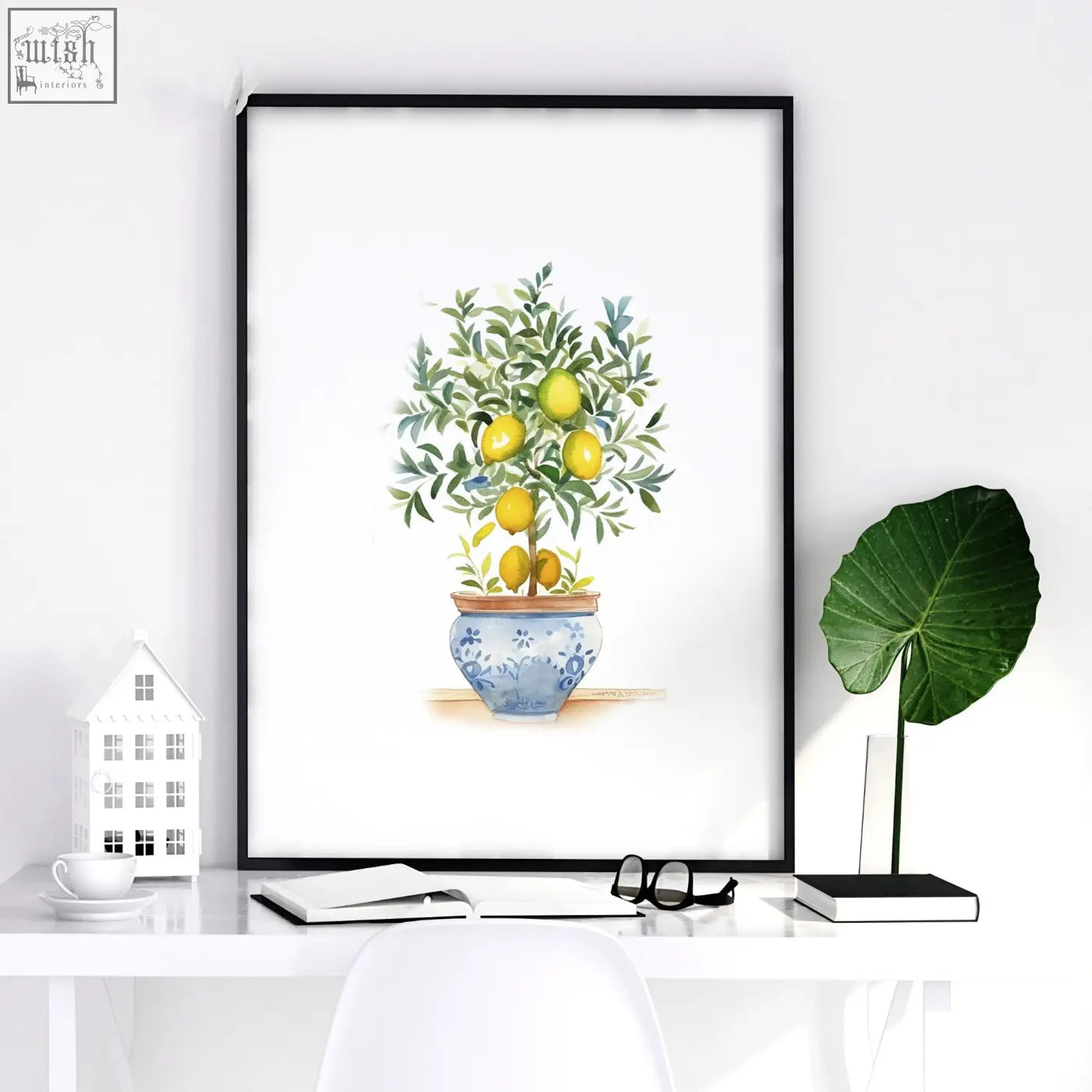 A framed green wall art watercolor print featuring a lemon tree in a blue and white ceramic pot