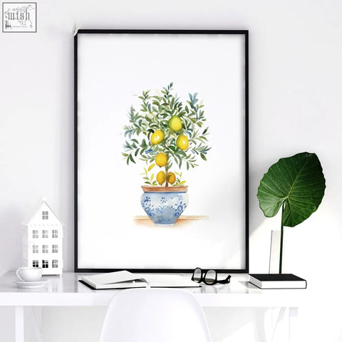 A framed green wall art watercolor print featuring a lemon tree in a blue and white ceramic pot