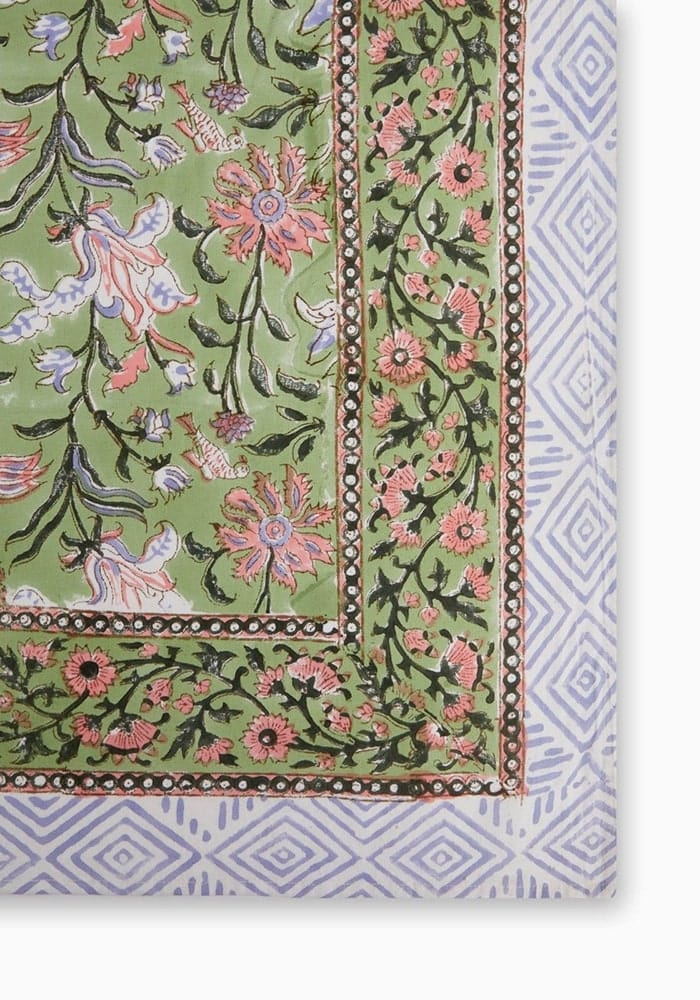 Green with envy tablecloth featuring a vibrant green floral print tablecloth with pink purple flowers and geometric border