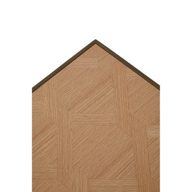 A light brown oak veneer floorboard with herringbone pattern and dark border under a brushed brass coffee table