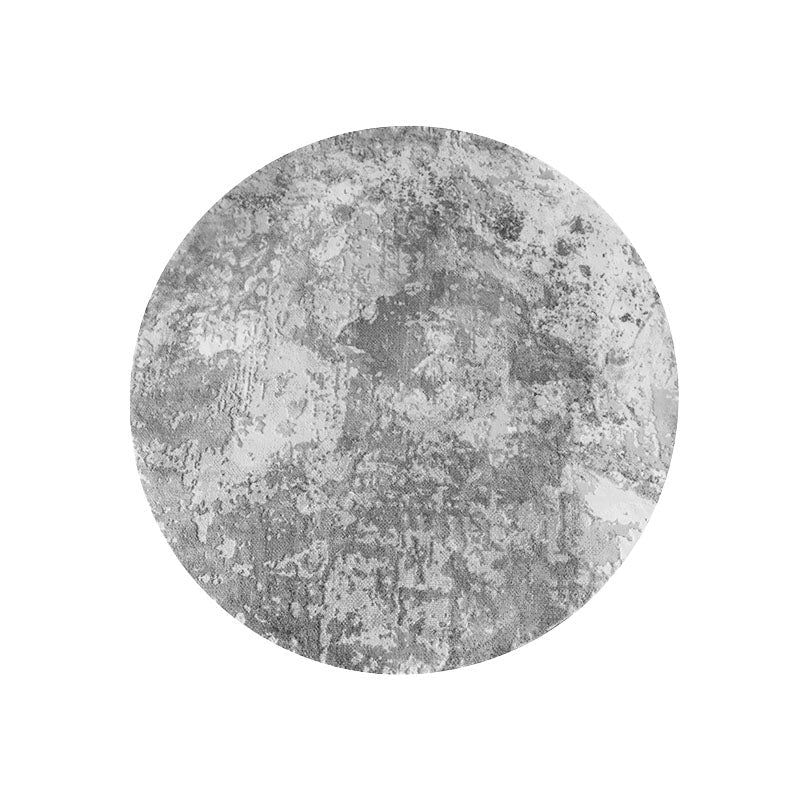 Circular gray textured moon rug with distressed mottled pattern in grey and white moon rug styles available