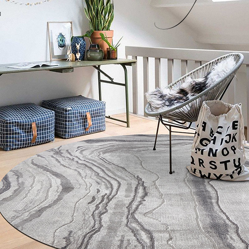 Gray and white marble patterned round moon rug featuring a stylish white moon design in various styles available