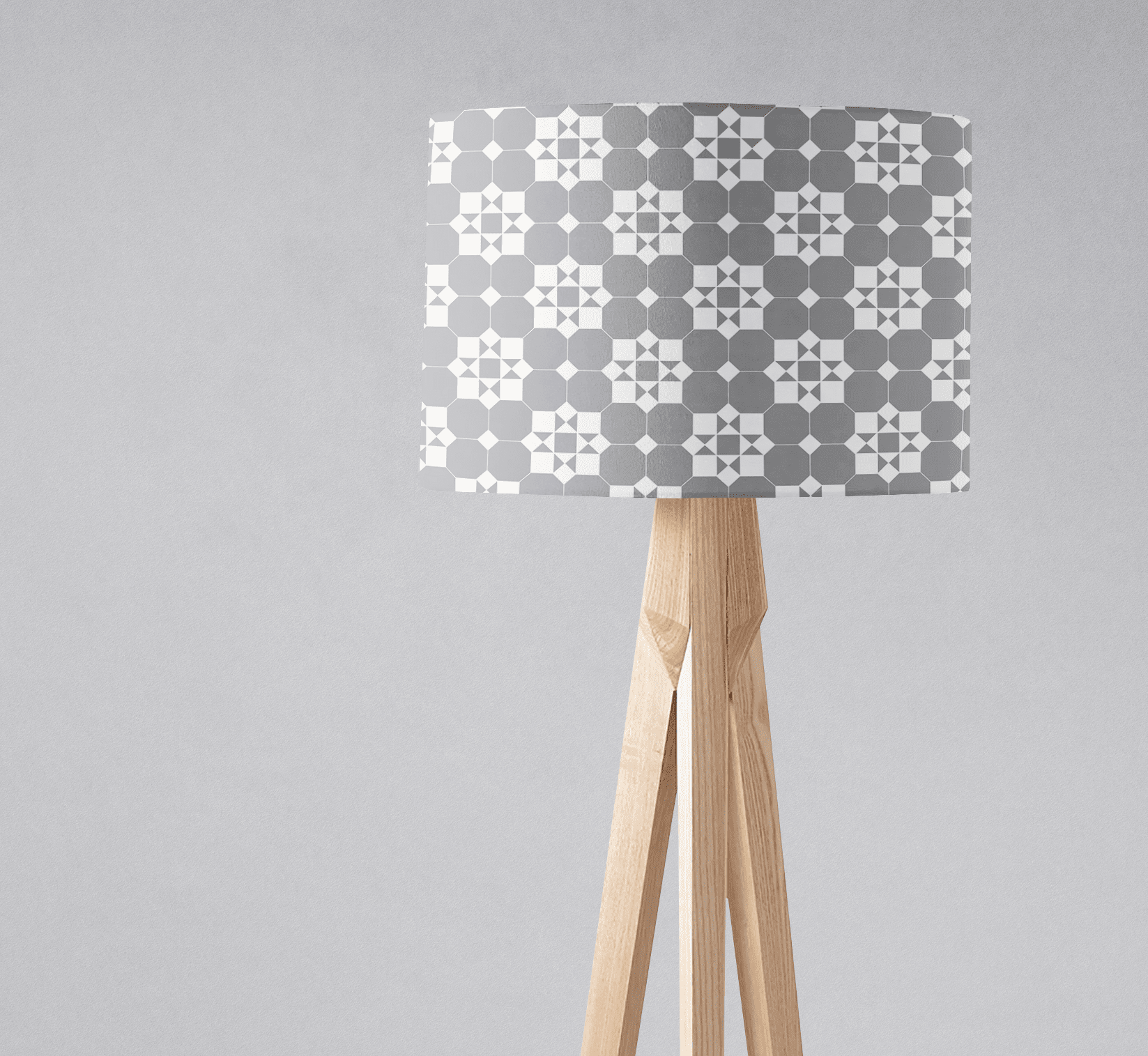 A modern tripod floor lamp with a gray and white tiles design geometric lampshade fabric and inch diameter shade