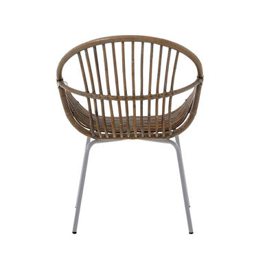 Grey wash natural rattan chair with curved back and seat supported by slim silver metal legs by lagom