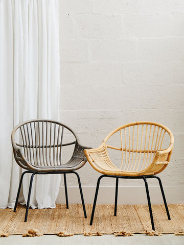 Two modern rattan chairs with black metal legs in grey wash natural and tan wash natural rattan by lagom
